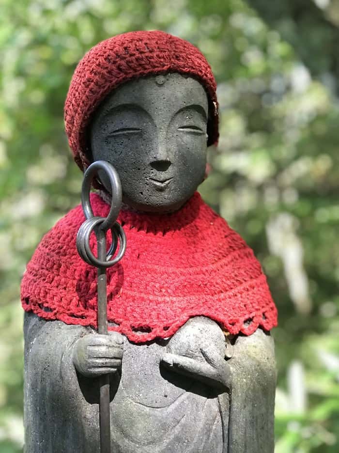 Jizo statue with red bib and hat, Jizo Pass, Nagano.