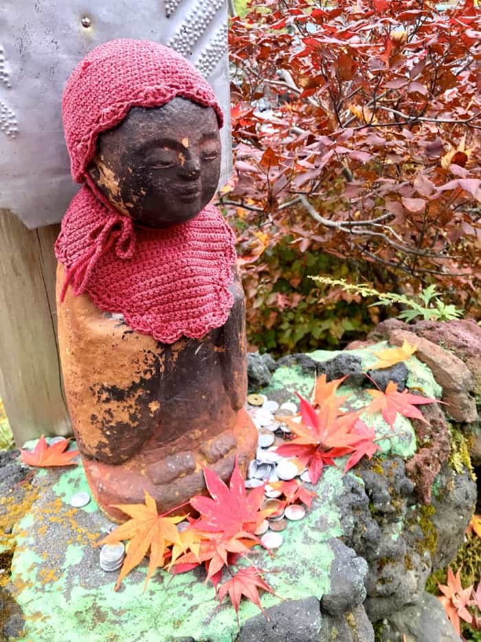 Jizo among autumn leaves.