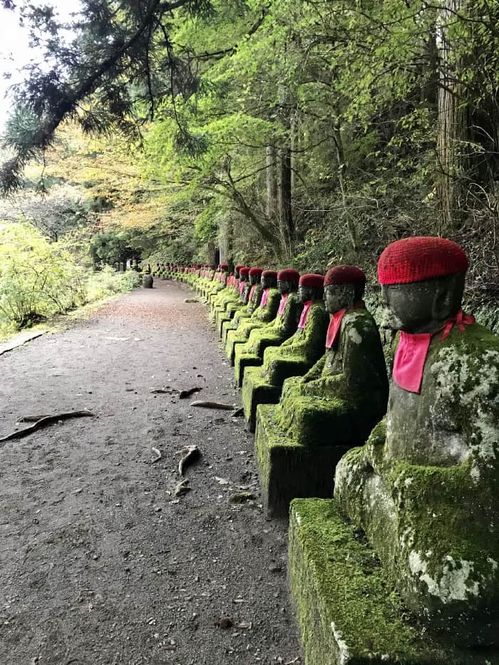Jizo statues in a long line at Kanman ga Fuchi in Nikko, Tochigi.