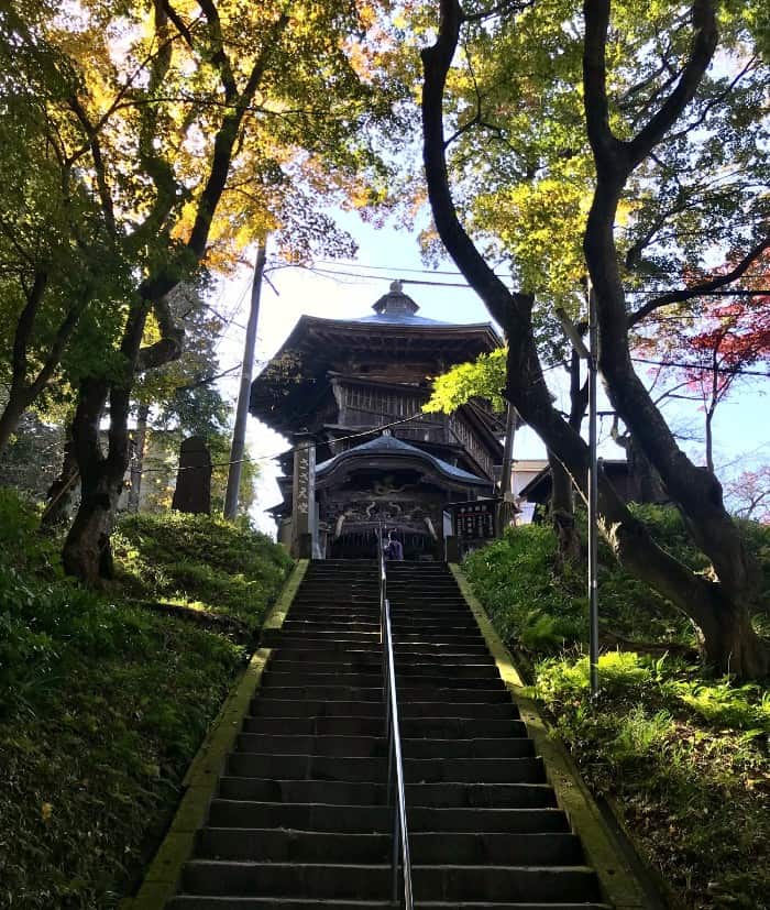 Looking up a steep staircase to Sazaedo.