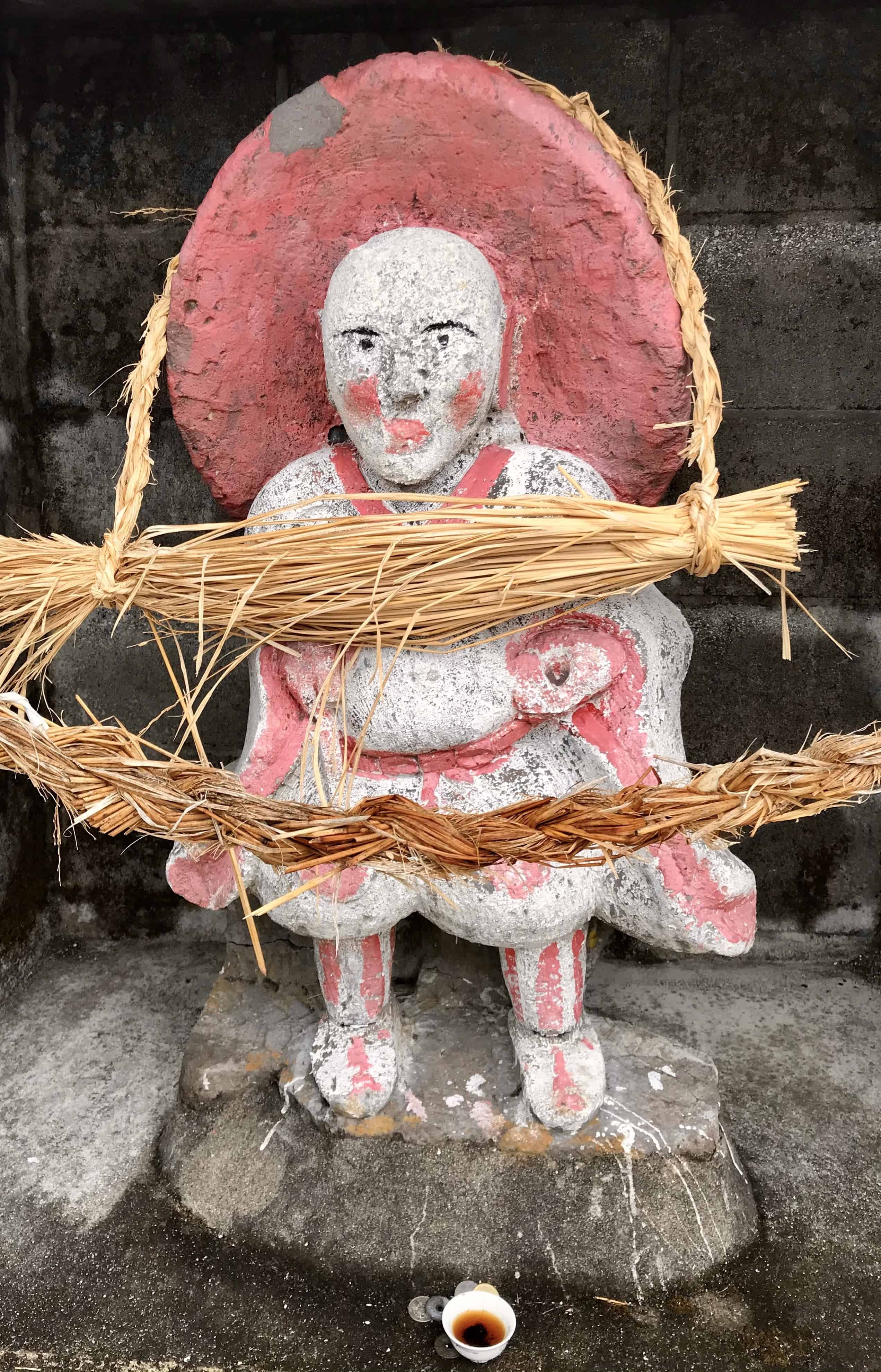 Rice field god holding offerings