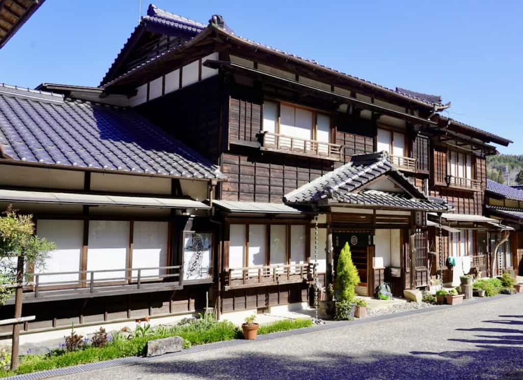 Beautiful old wooden inn backed by clear blue sky.