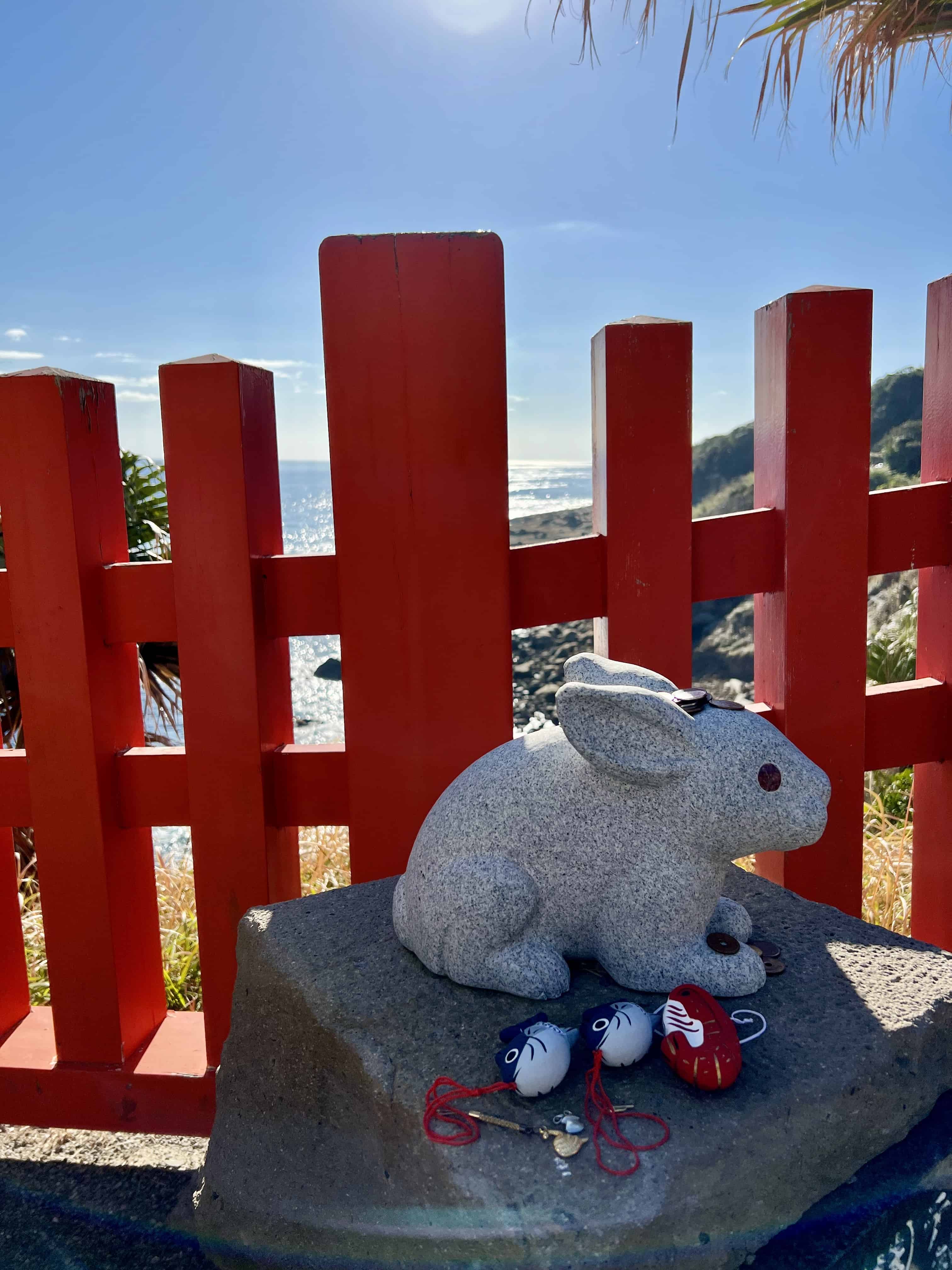 Rabbit statue with offerings — along the path to Udo Shrine.