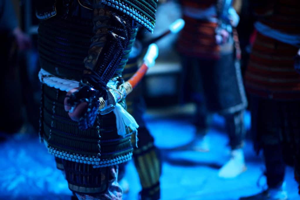 Samurai sword and armor in dark blue light.