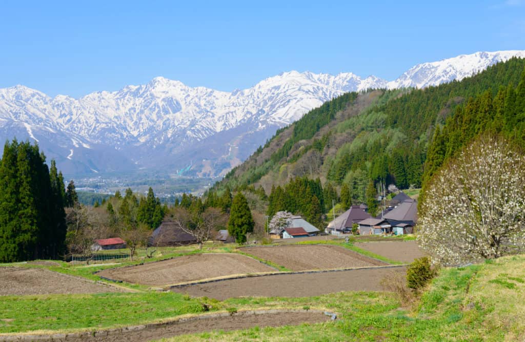Rice fields, traditional houses, and mountains along the Salt Road, Nagano.