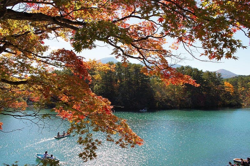 Autumn leaves frame the blue-green waters of Bishamon-numa Pond.