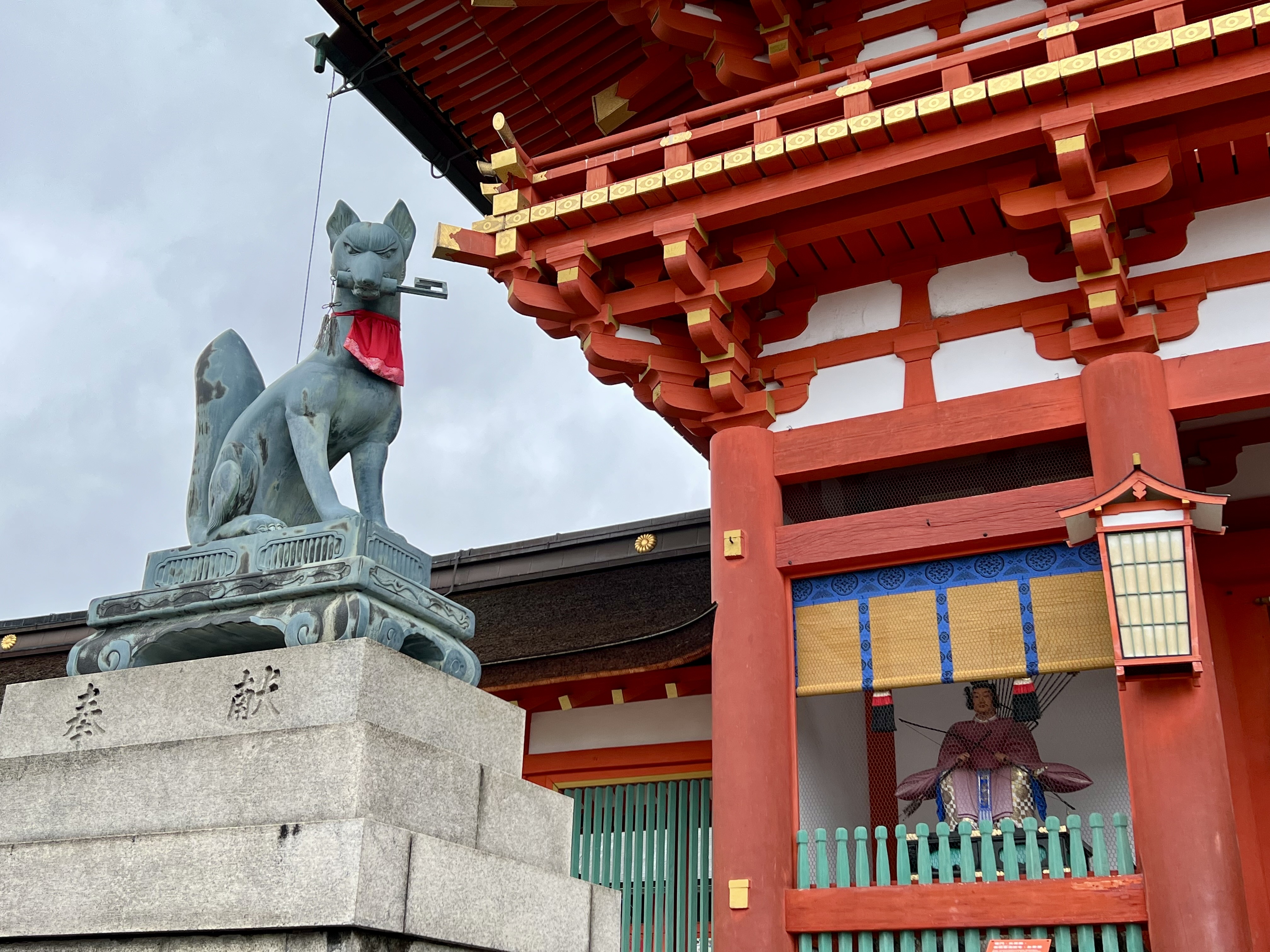 Inari fox guardian holding granary key at Fushimi Grand Shrine.