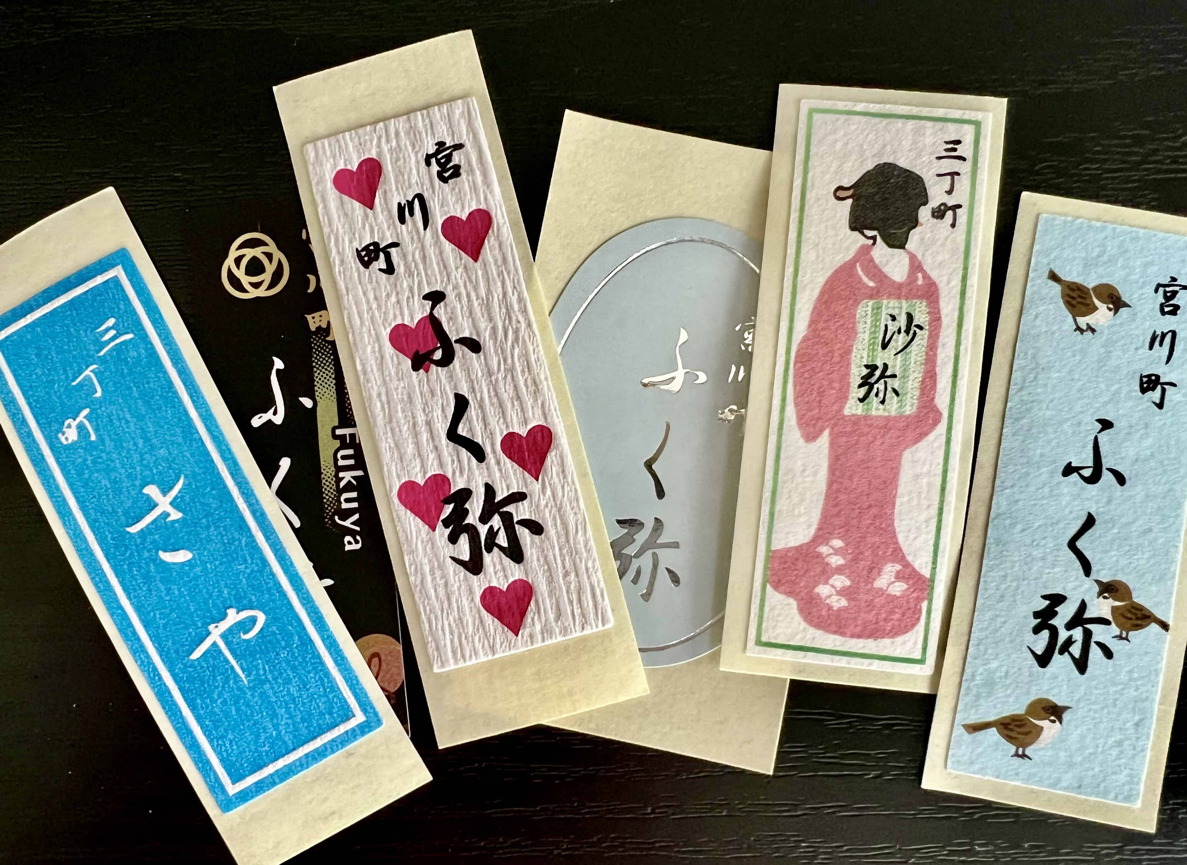 Colorful stickers with writing and an illustration of a woman in a kimono.