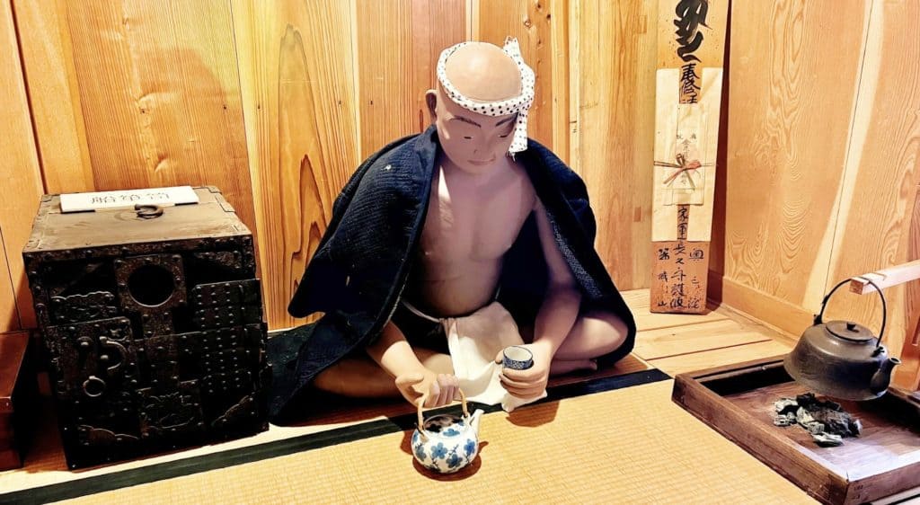 Kitamaebune shipmaster having tea aboard ship.