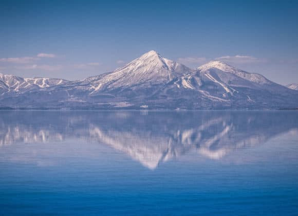 Snow-capped Mount Bandai is reflected in the still waters of Lake Inawashiro, Fukushima.