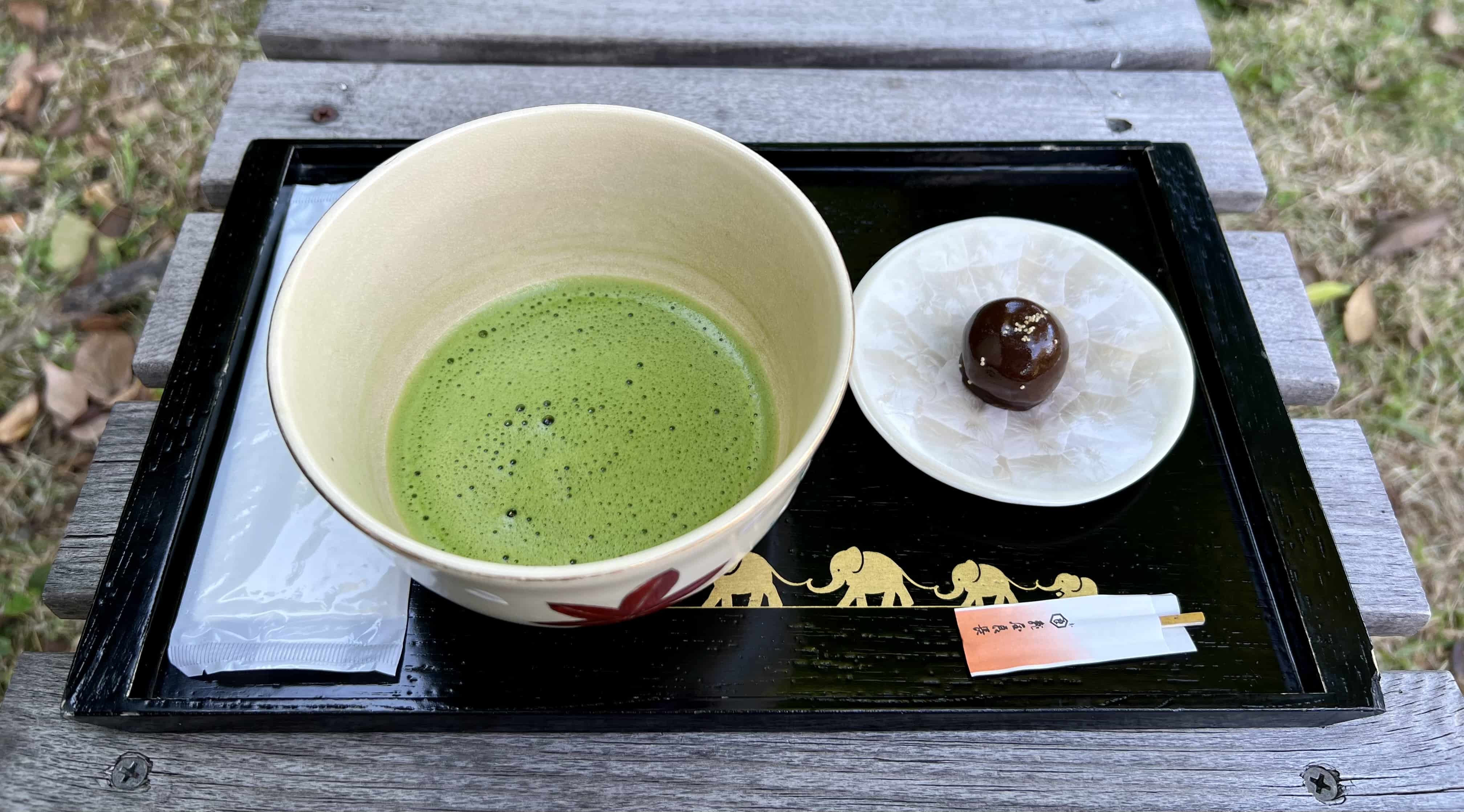 Small gold-flaked wagashi served with matcha tea.