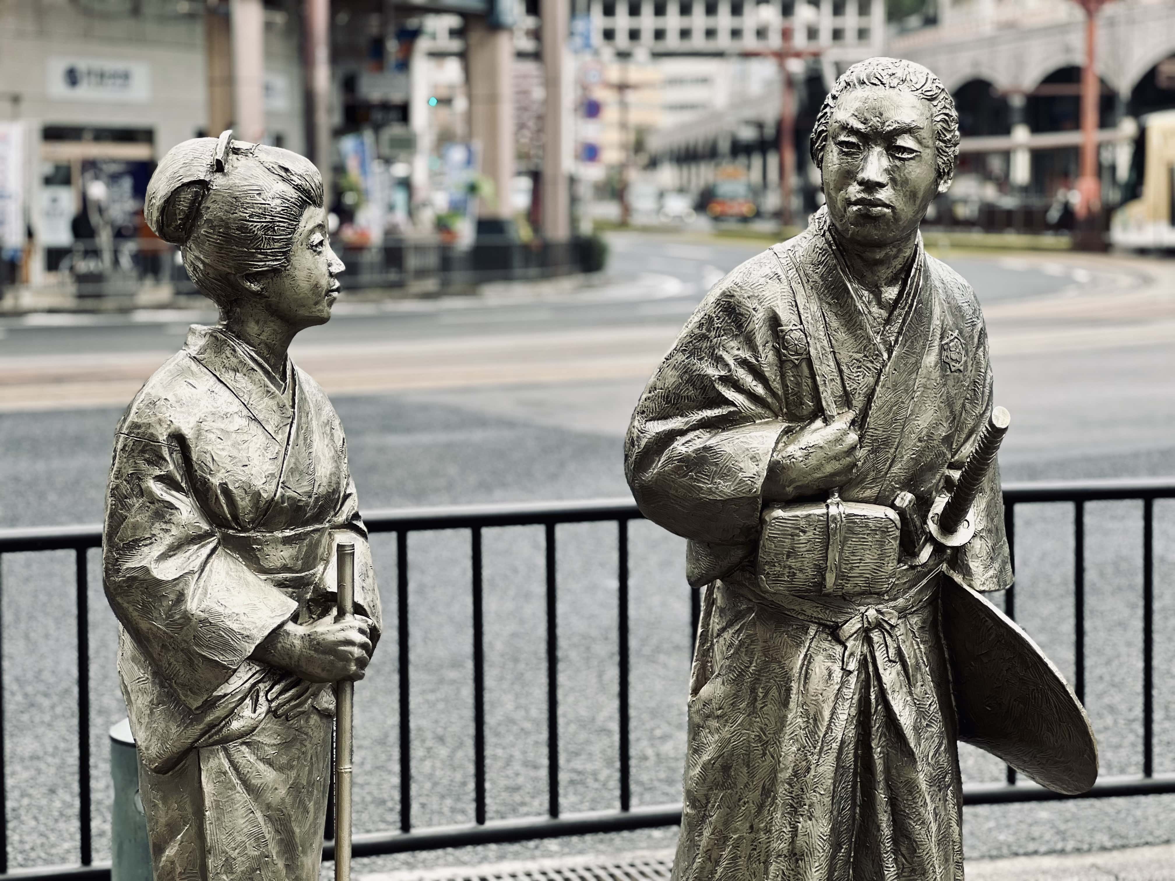 Sakamoto Ryoma and his wife, immortalized in bronze, walking the streets of Kagoshima.
