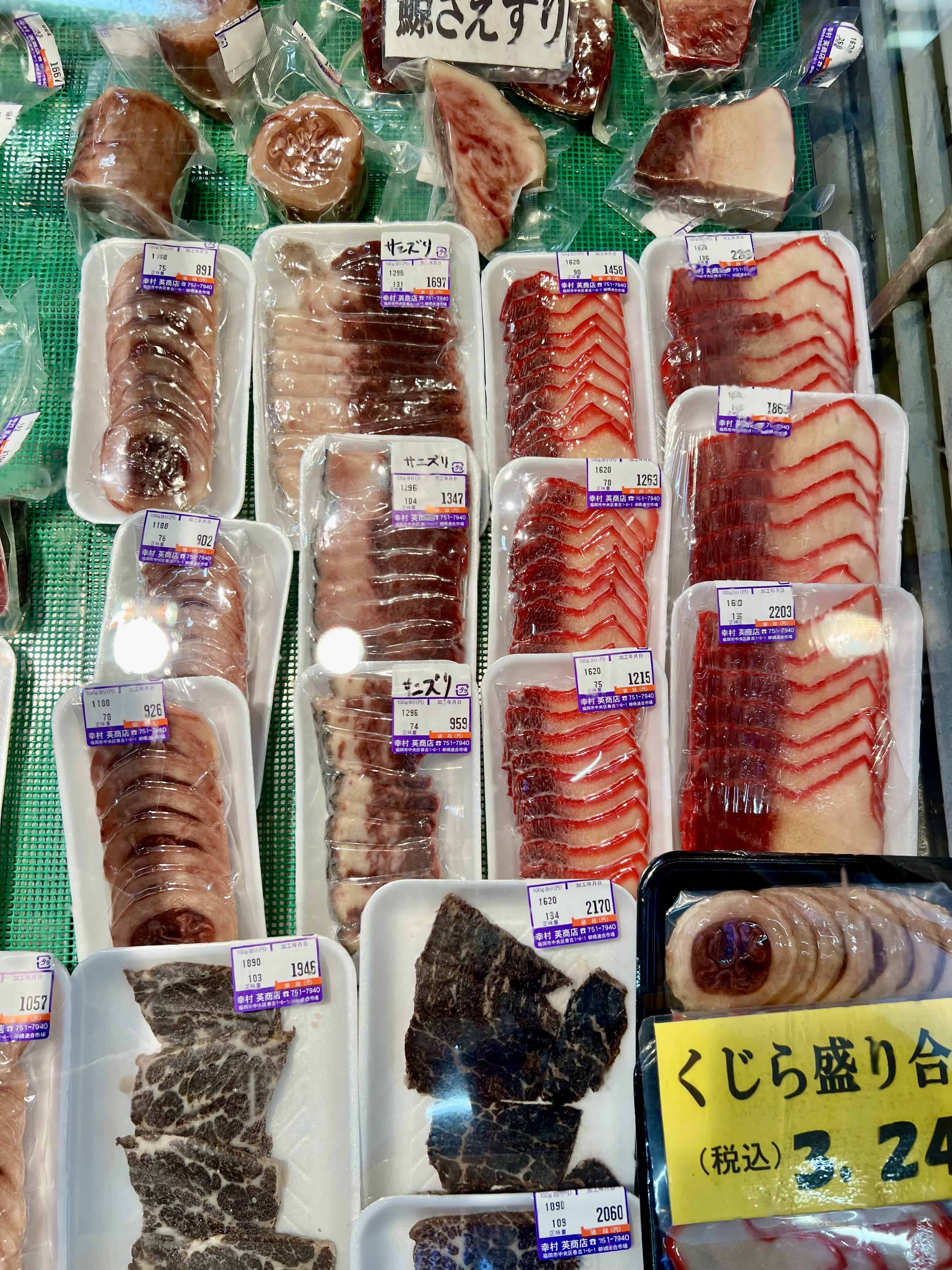 Plastic wrapped packages of whale meat on display in a market.