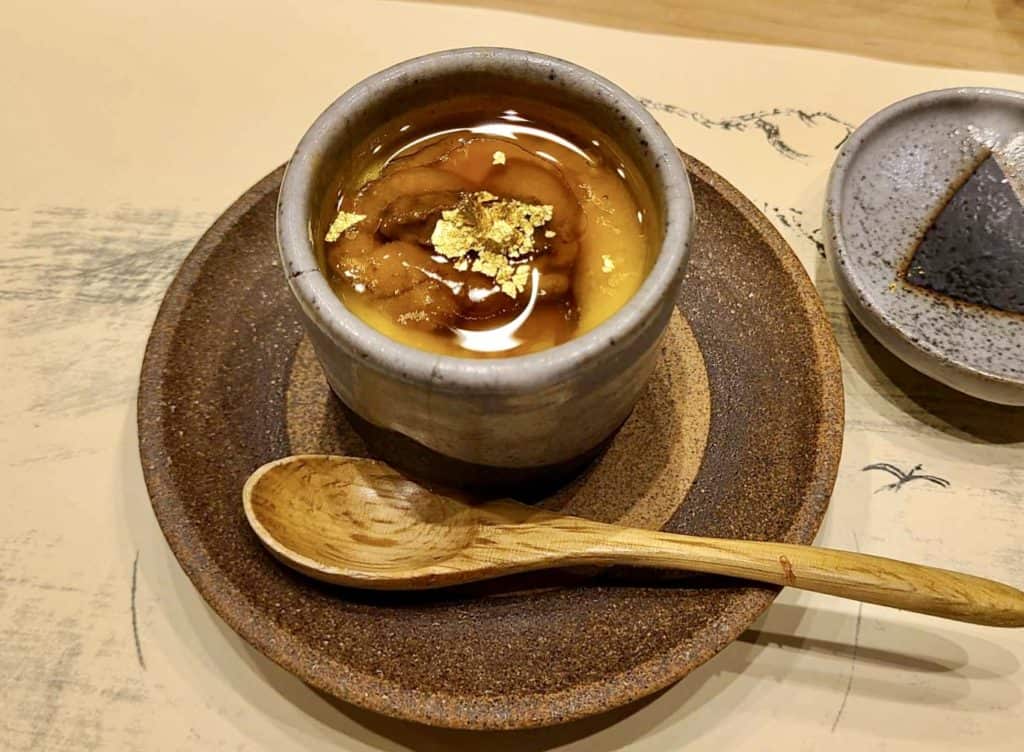 Uni and gold may be considered weird, but they are not the strangest food I've had. This small pottery bowl of savory egg custard topped with broth, uni, and gold leaf was delicious.