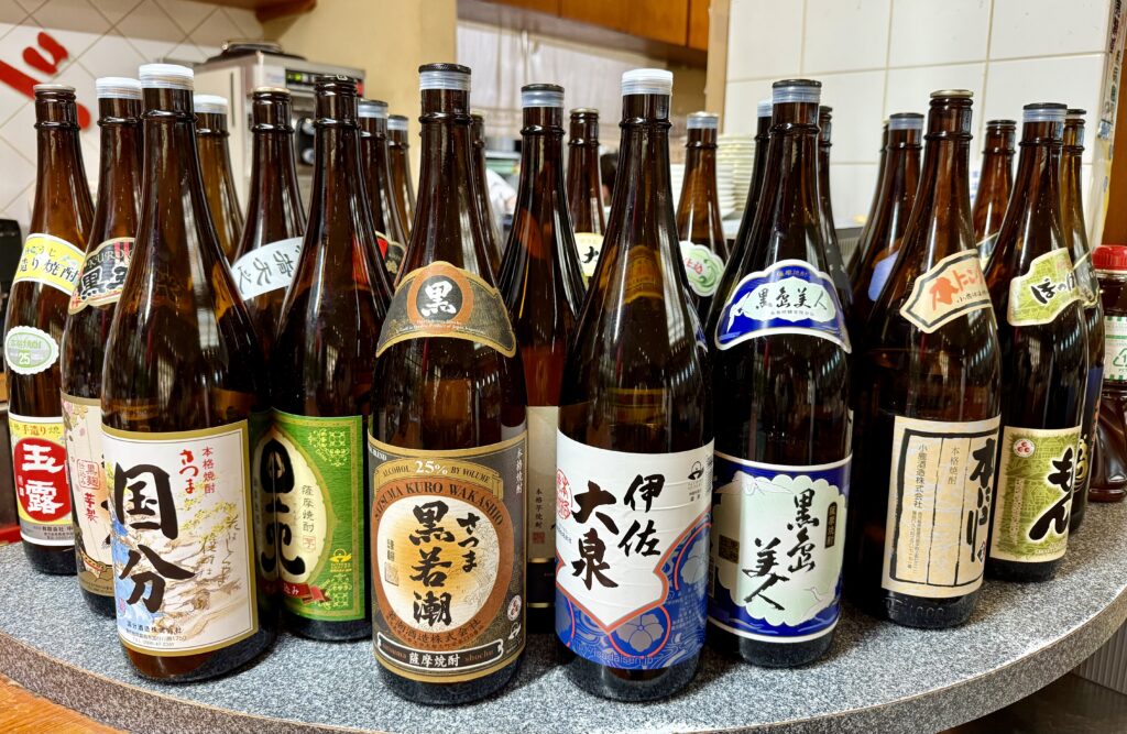 Shochu bottles on display in a restaurant.