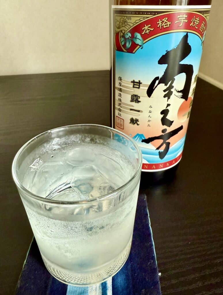 Frosty glass of shochu beside bottle.